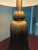 Art Deco-inspired table lamp by Haig, featuring a sculptural fluted brass body with a distinctive tapered form. The deeply...