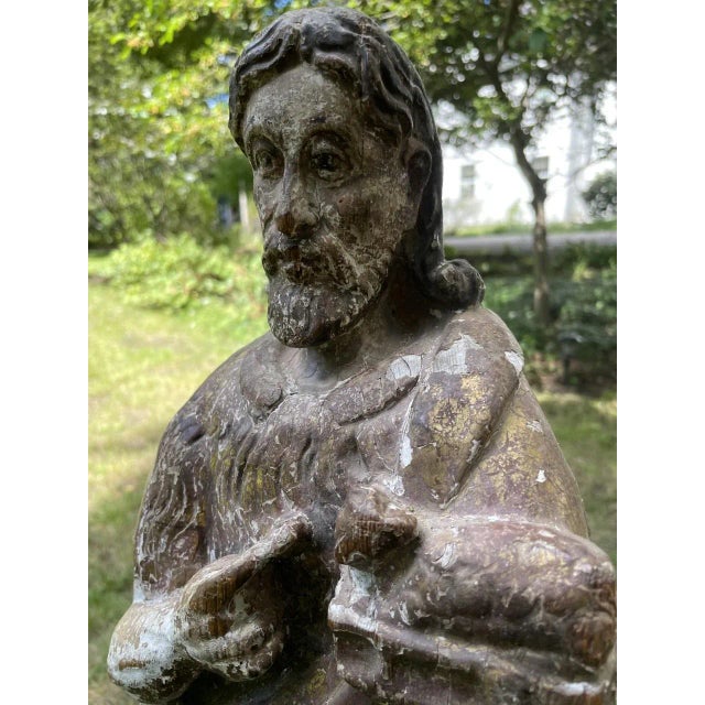 European Santos figure. Carved from a single piece of wood depicting Christ holding a lamb, with a finger pointing at it....