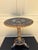 An exceptionally charming early 20th century chinoiserie painted wood drinks table featuring a richly patinated black...