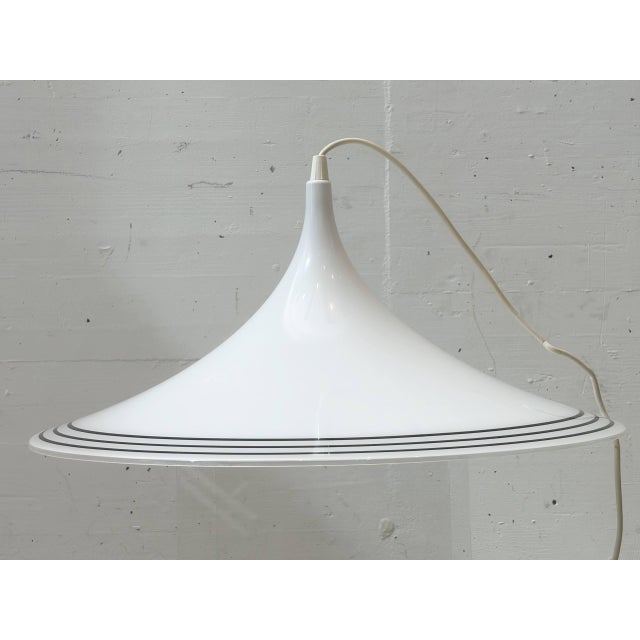Meblo's signature pendant lamp embodies the futuristic design language of 1970s space-age aesthetics. The elegantly curved...