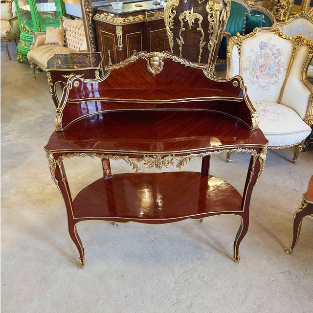 French table from the time of Napoleon III in precious exotic wood with bronze and gold leaf applications. This table can...