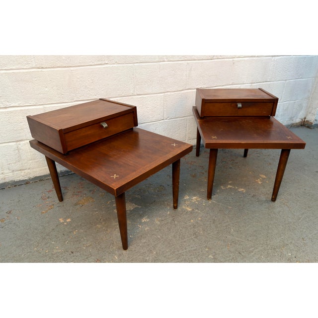 A striking pair of Mid-Century Modern “Accord” step-up end tables, designed by Merton Gershun for American of...