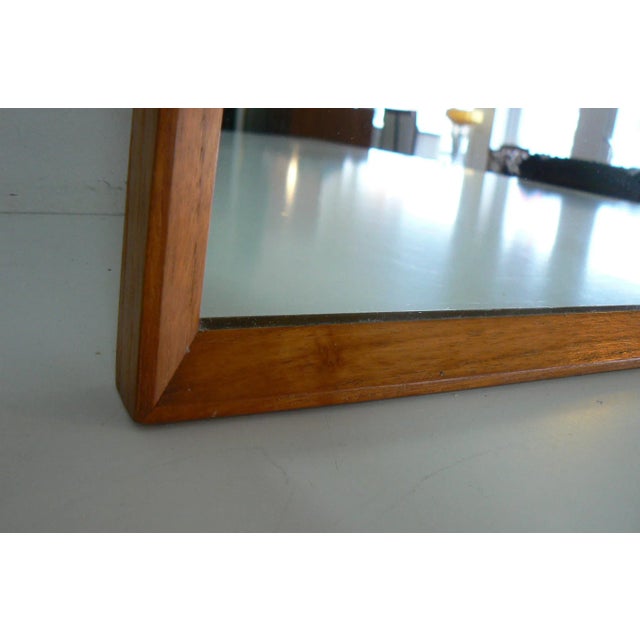 This Danish teak mirror was designed in the 1960s and remains in its original condition.