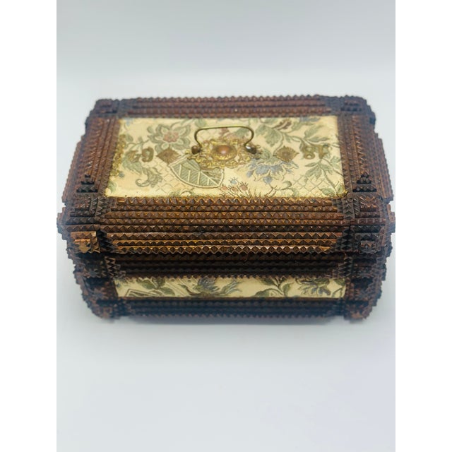 This is a charming late 19th-century Tramp Art jewelry or keepsake box, handcrafted from layered and chip-carved wood. The...