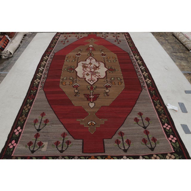 While the medallion design is the visual focal point of this hand-made vintage Turkish kilim rug, the bright gold...