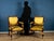 An elegant pair of Empire-style armchairs, crafted in the early 19th century, featuring a stately silhouette and refined...