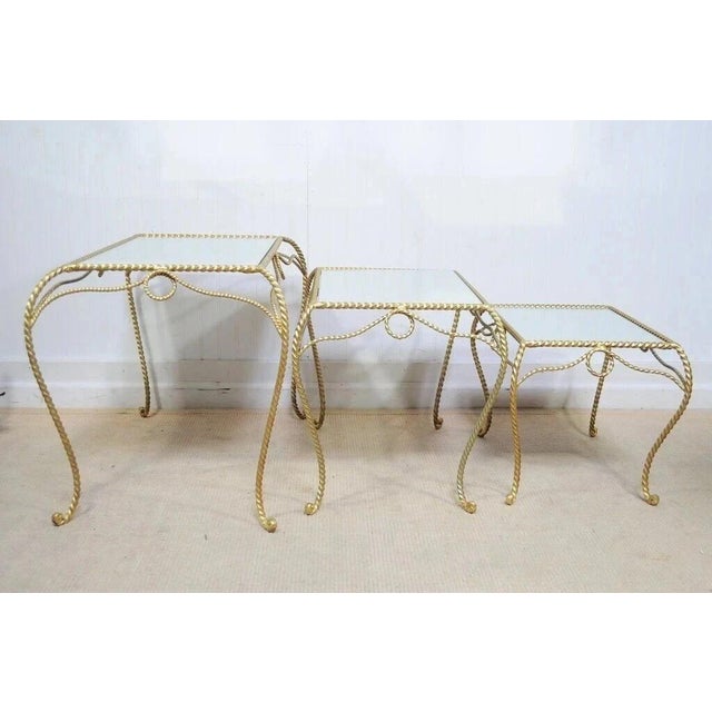 Vintage Italian Hollywood Regency Wrought Iron Gold Rope Form Mirror Top 3 Pc Nesting Side Tables. Item features scrolling...