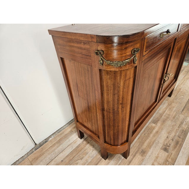 An elegant Art Nouveau sideboard from the early 20th century, crafted from walnut with a refined exposed grain and...
