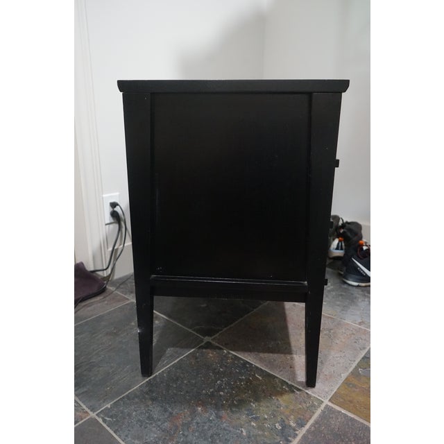 With a sleek, minimalist design, this piece features a deep black-stained frame and subtle cutaway handles for a...