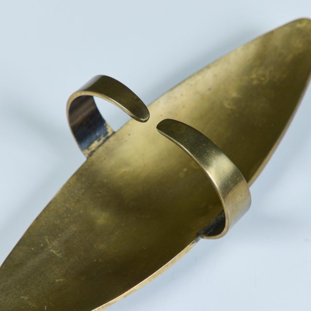 Mid-century brass Pal-Bell tray features an elongated oval shape with two curved handles at the center. Embossed stamp on...