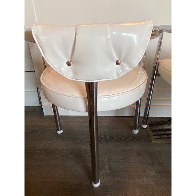 Restored Mid Century Modern Chrome dining chairs with 3 legs. Newly upholstered in white faux patent leather with self...