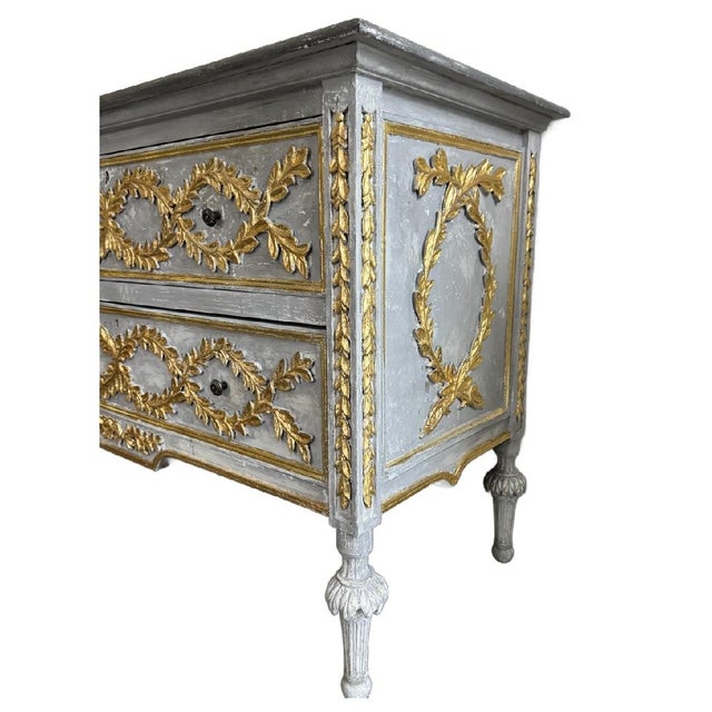 Enhance your environment with this exquisite vintage neoclassical gilt-tipped commode, embodying timeless elegance and...