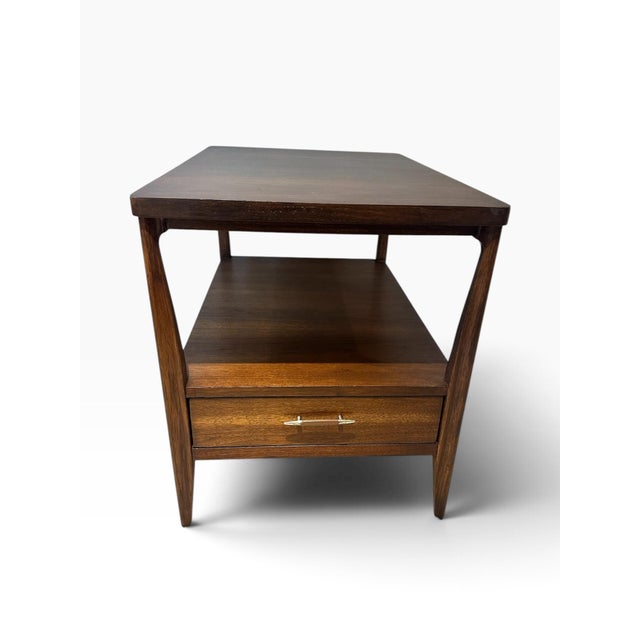 Bring authentic 1960s heritage into your home with this striking Broyhill Saga Mid-Century modern two-tier end table with...