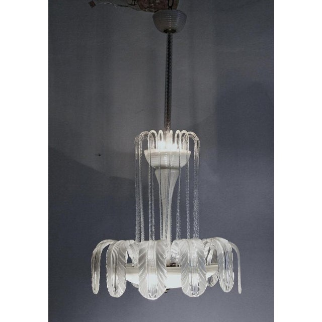 Sophisticated chandelier by ercole barovier. A rare and beautiful chandelier, the lower bowl is hand-opened horizontally...