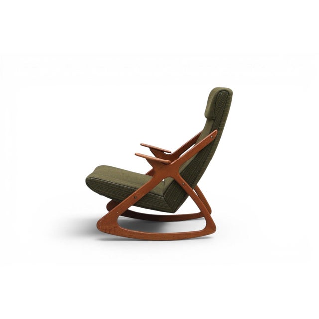 An extraordinary 1950s Danish atomic-age highback rocking chair in solid teak. The dramatically tall back, bold teak...