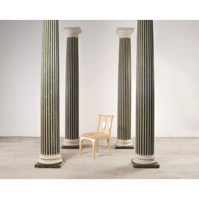 An exceedingly rare and imposing set of four monumental Doric style Greco-Roman columns constructed in a richly detailed...