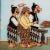 In this charming reverse glass painting, the iconic Javanese figure Petruk is humorously portrayed in an unlikely role--...