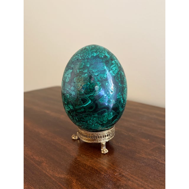 A stunning Russian style large malachite egg on Neoclassical style stand with paw feet Late 20th century Solid malachite...