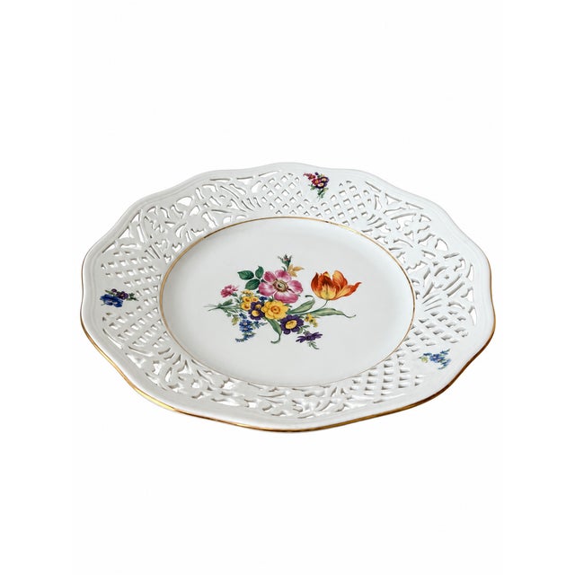 An elegant Thun porcelain display plate featuring a broad pierced border of alternating latticework and scrolling...