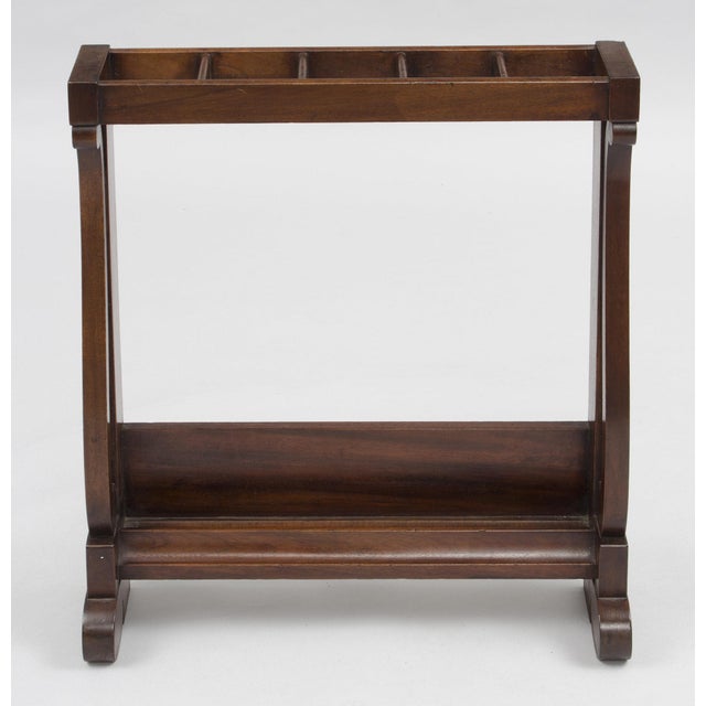 American very shallow mahogany umbrella stand with four openings. Labels underneath read: Lord & Taylor, New York. F.B.M....