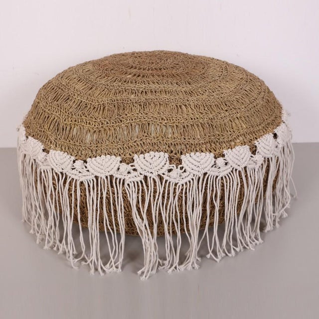 Our product is entirely handcrafted from natural raffia, with the edges elegantly shaped using macrame yarn. This...