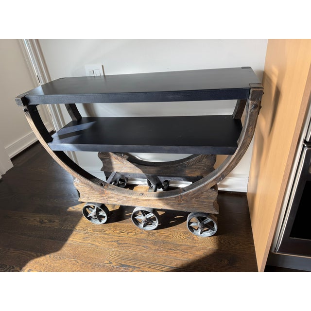 A striking Restoration Hardware bar cart featuring RH’s signature industrial‑modern aesthetic. The sculptural star‑spoked...