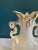 This exquisite vintage ceramic vase showcases elaborate Rococo-inspired curves with delicate scroll handles and a fluted...