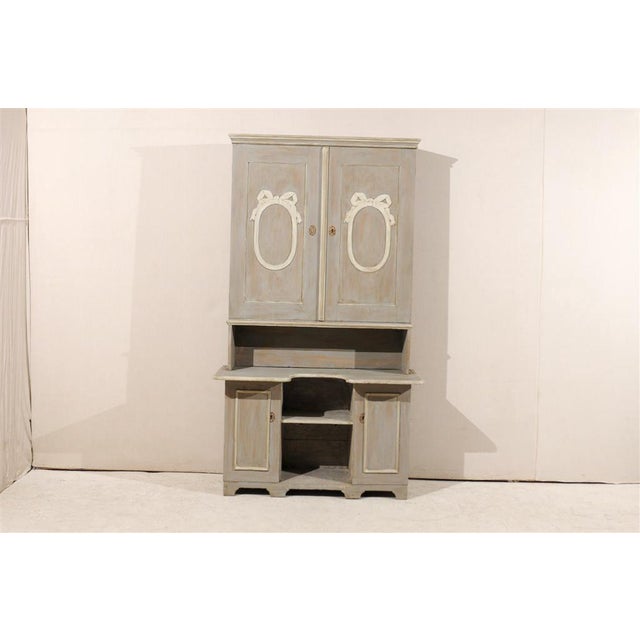 A Swedish Early 19th Century Painted Wood "Skap" Cabinet with opened shelves, multiple inner Shelves and oval ribbon...