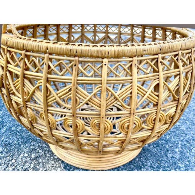 A vintage woven rattan basket with handle. Highly detailed geometric patterns throughout with star pattern at center. Very...