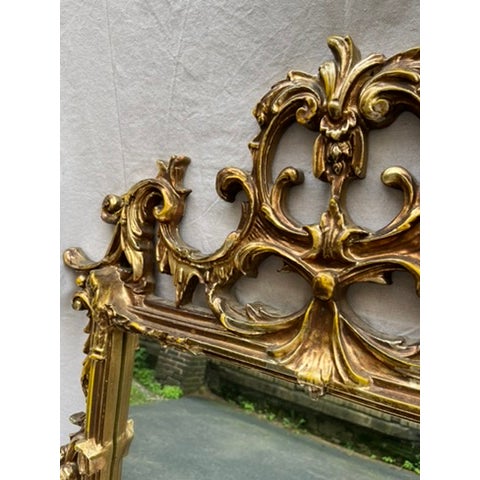 A single vintage rectangular shaped wall mirror with gold chinoiserie style frame.