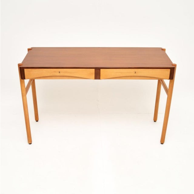 A stylish and beautifully designed vintage Swedish walnut desk by Bertil Fridhagen. This was recently imported from...