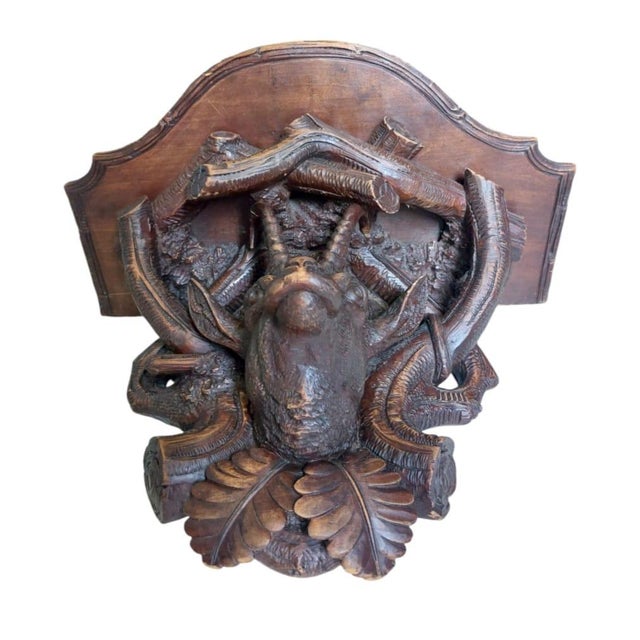 This wonderful unique more than rare shelf or Wall console with a carving head of ibex with labyrint of Woods and holding...