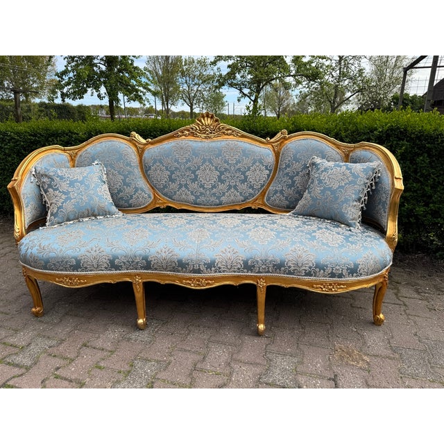 An impressive 1940 French Louis XVI-style sofa set, fully handmade in Europe from solid beech wood and consisting of one...