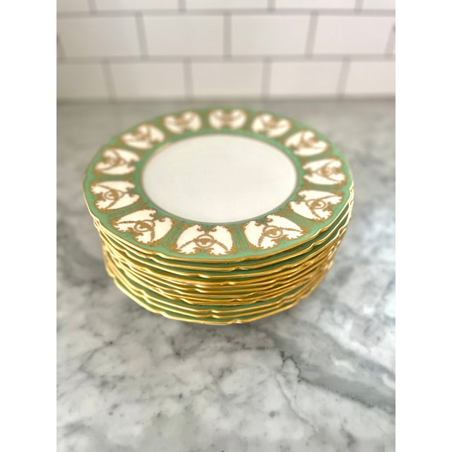 A beautiful set of 12 Royal Doulton England porcelain plates circa 1902-1922. Finely decorated with raised gold gilt and a...