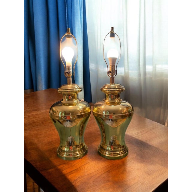 A pair of large brass ginger jar lamps. Original harp and finial. 19” tall to top of jar and 25” to top of harp. 10.5”...