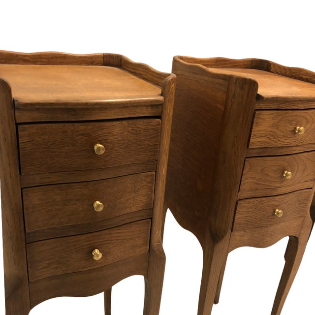 Pair of Louis XV style bedside tables. Made of solid oak with a slightly glossy varnish. They feature gently curved...