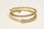 A stylish triple band of 18K gold with round, brilliant cut diamonds in a pave` setting. Each end capped off with a...