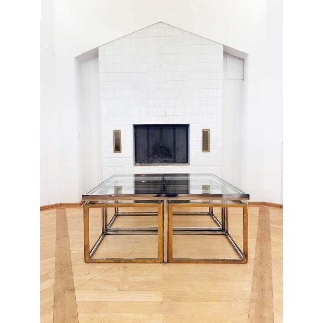 A striking large bicolor brass and chrome coffee, center, or cocktail table featuring four pull-out nesting side tables,...