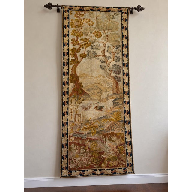 This antique English needlepoint tapestry runner dates to the early 20th century, circa 1920, and features a finely...