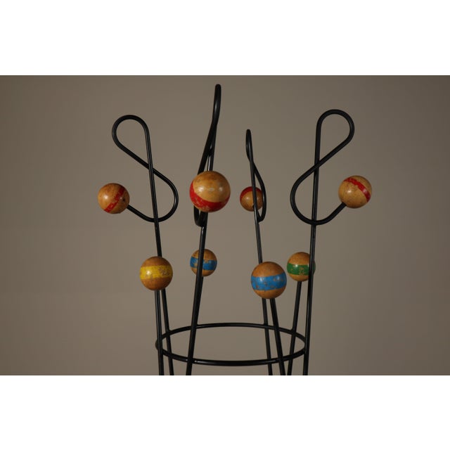 Decorative contemporary freestanding coat and hat stand in the style of the playful mid-century designs associated with...
