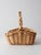 A vintage handwoven gathering basket in a light natural tone, shaped with a softly squared form and a thick, twisted...