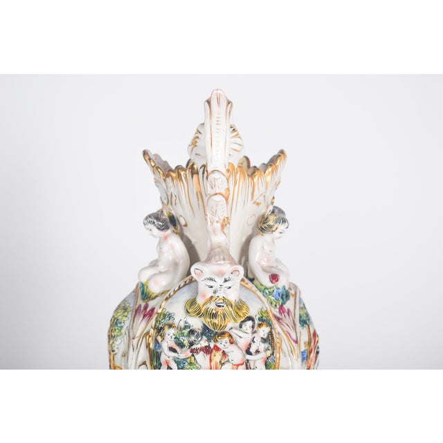 Pottery jar in the shape of an amphora. Polychrome and gold decoration worked in relief with leaves and other ornaments....