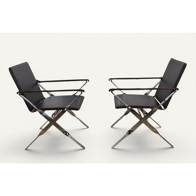 An elegant pair of folding armchairs from the 1970s, likely of Italian manufacture, combining a polished chrome metal...