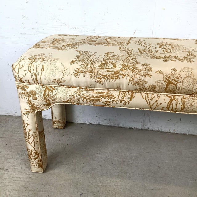This upholstered bench draws from Louis XVI–inspired design, pairing refined proportions with a classic toile fabric. The...