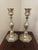Beautiful pair of candle sticks are brass with silver plating. The plating has worn thin so they have a soft gold glow...
