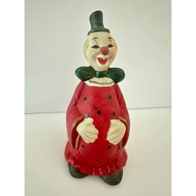 Vintage porcelain clown bell. Red with black polka dots. Approximately 2” x 2” x 5”.