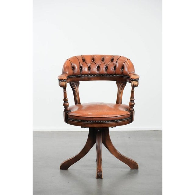 Classic and timeless cowhide and wooden Chesterfield office chair finished with decorative nails in the English style. :...