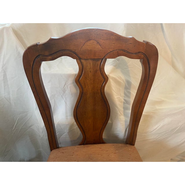 This is a sturdy side chair for dining or extra seating. It sports an upholstered padded seat in a salmon nubby fabric,...