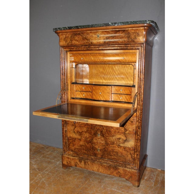 A Louis Philippe period secretary desk in burr walnut, it opens with a molded drawer in the upper section and three...