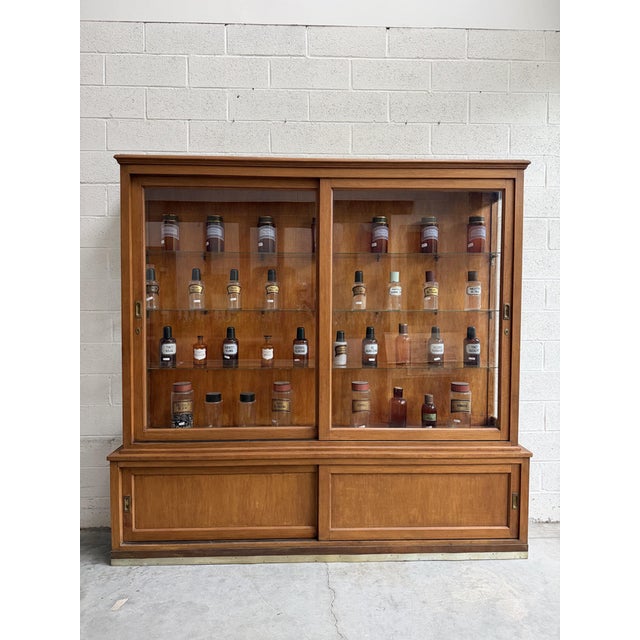 This 1950s display case has been completely restored. It features a glass-fronted upper section on the front and sides....